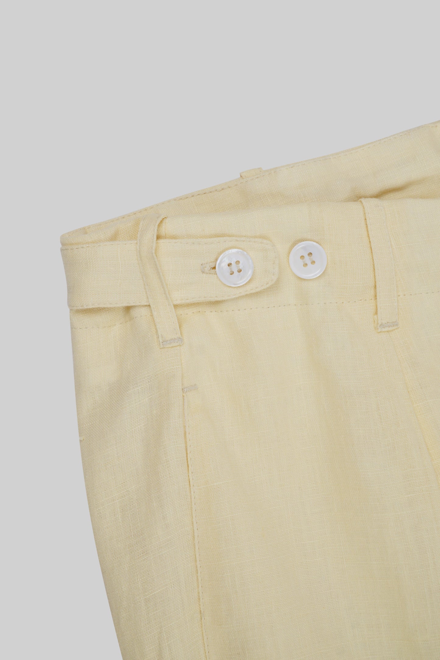 Light beige linen pants from Bross Before HOS Boutique, featuring a relaxed fit and tailored waistband.
