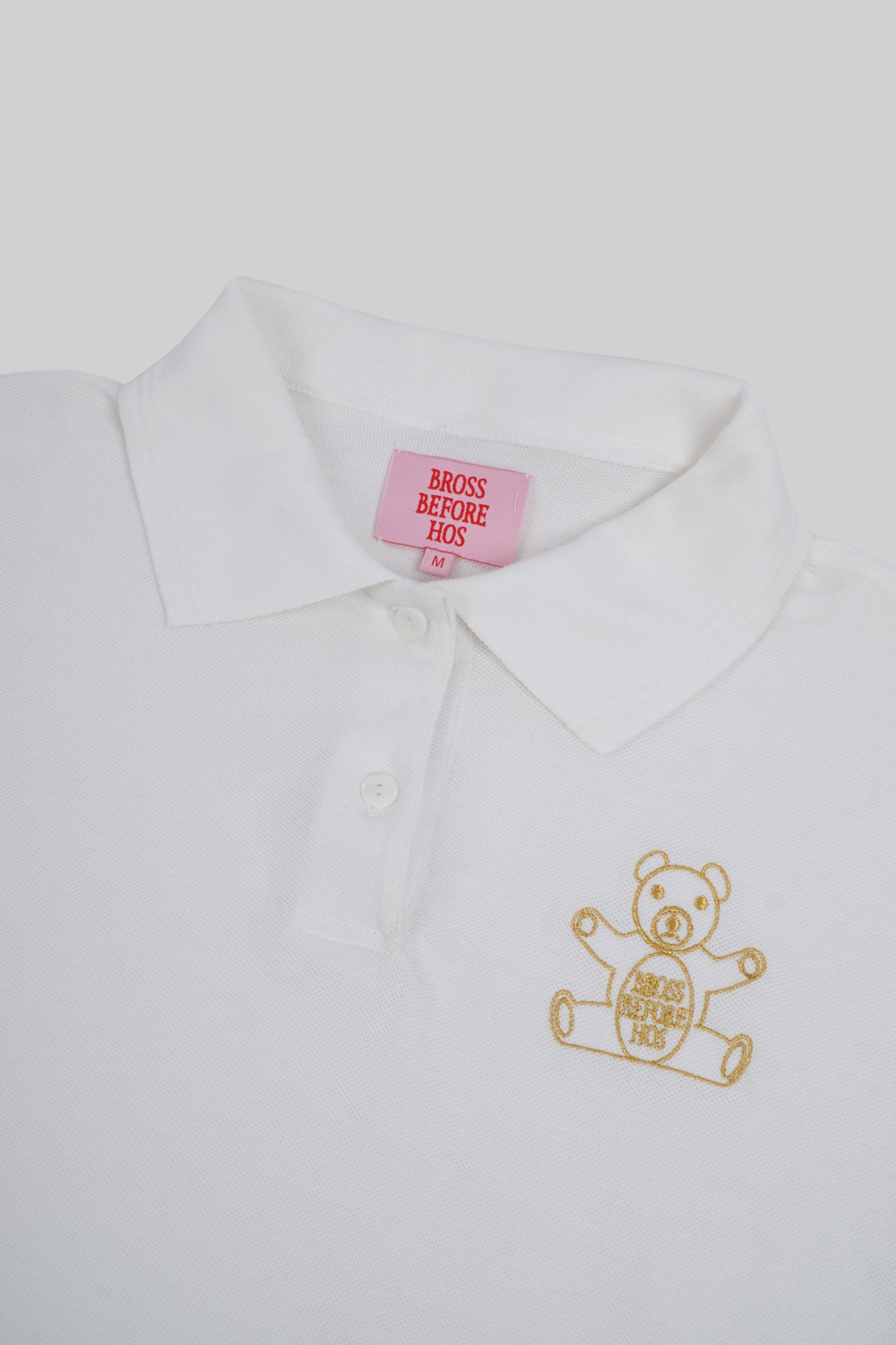 Women’s polo T-shirt by Bross Before Hos Boutique, featuring a classic fit and soft fabric, shown on a hanger.