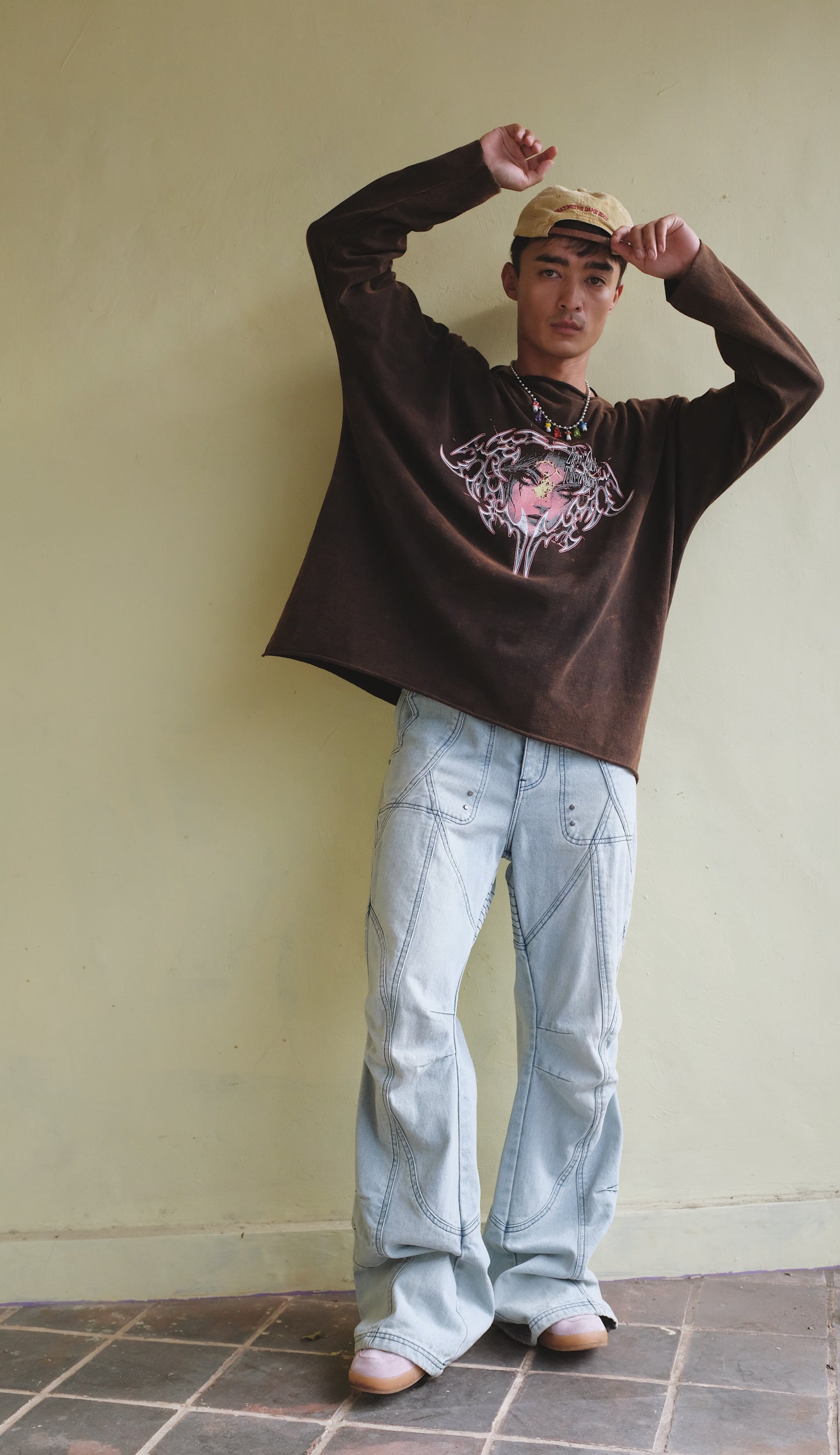 Brown long sleeve T-shirt with a face print from Bross Before Hos Boutique, featuring a casual fit and artistic graphic design.