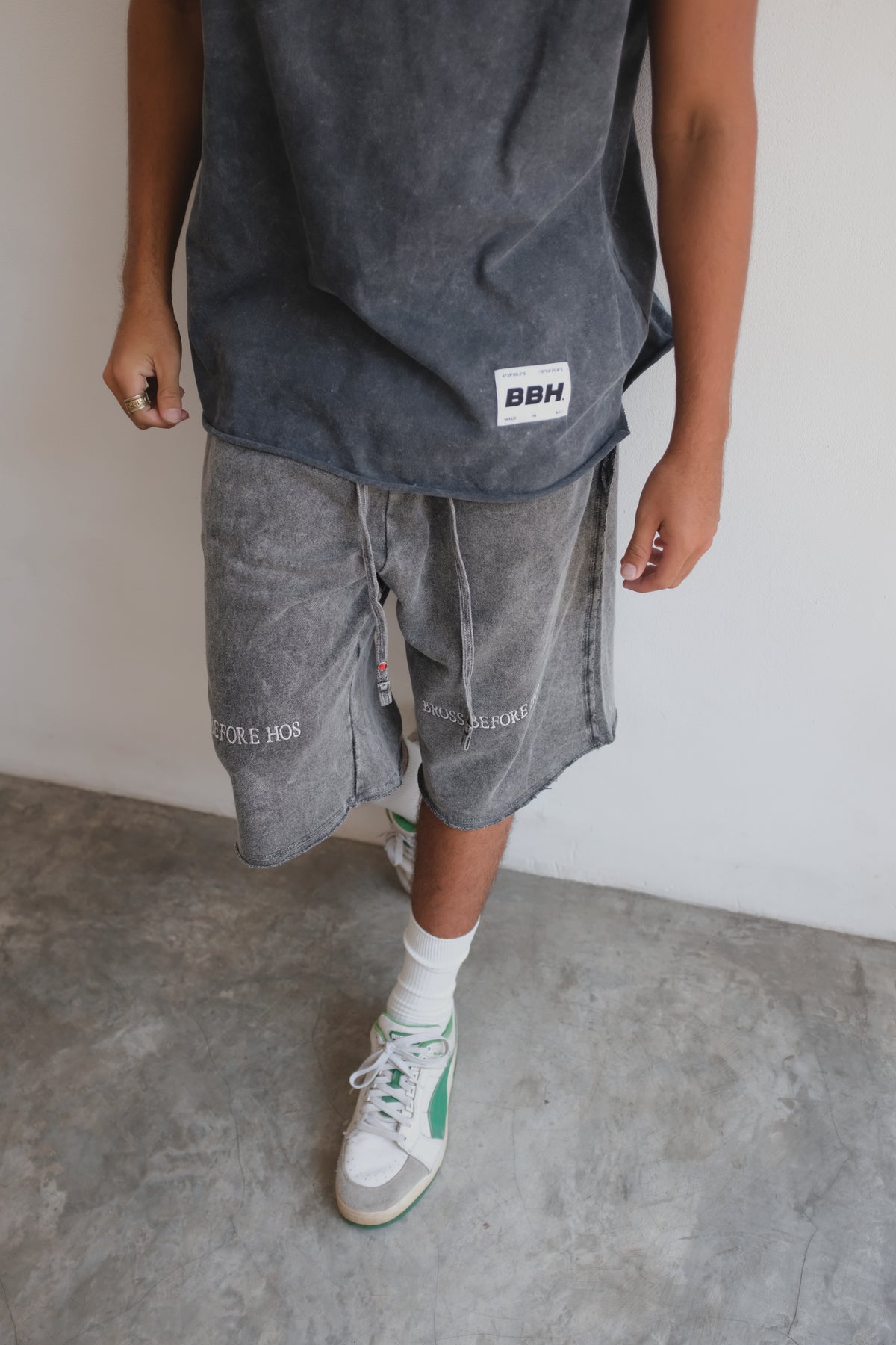 Black French Terry long shorts from Bross Before H Os Boutique, shown on a hanger with a relaxed fit and comfortable fabric.