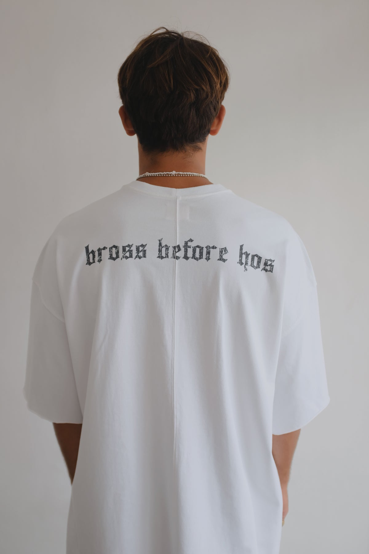 Black BROSS BEFORE HOS BOUTIQUE T-shirt featuring a bold printed skull design on the front.
