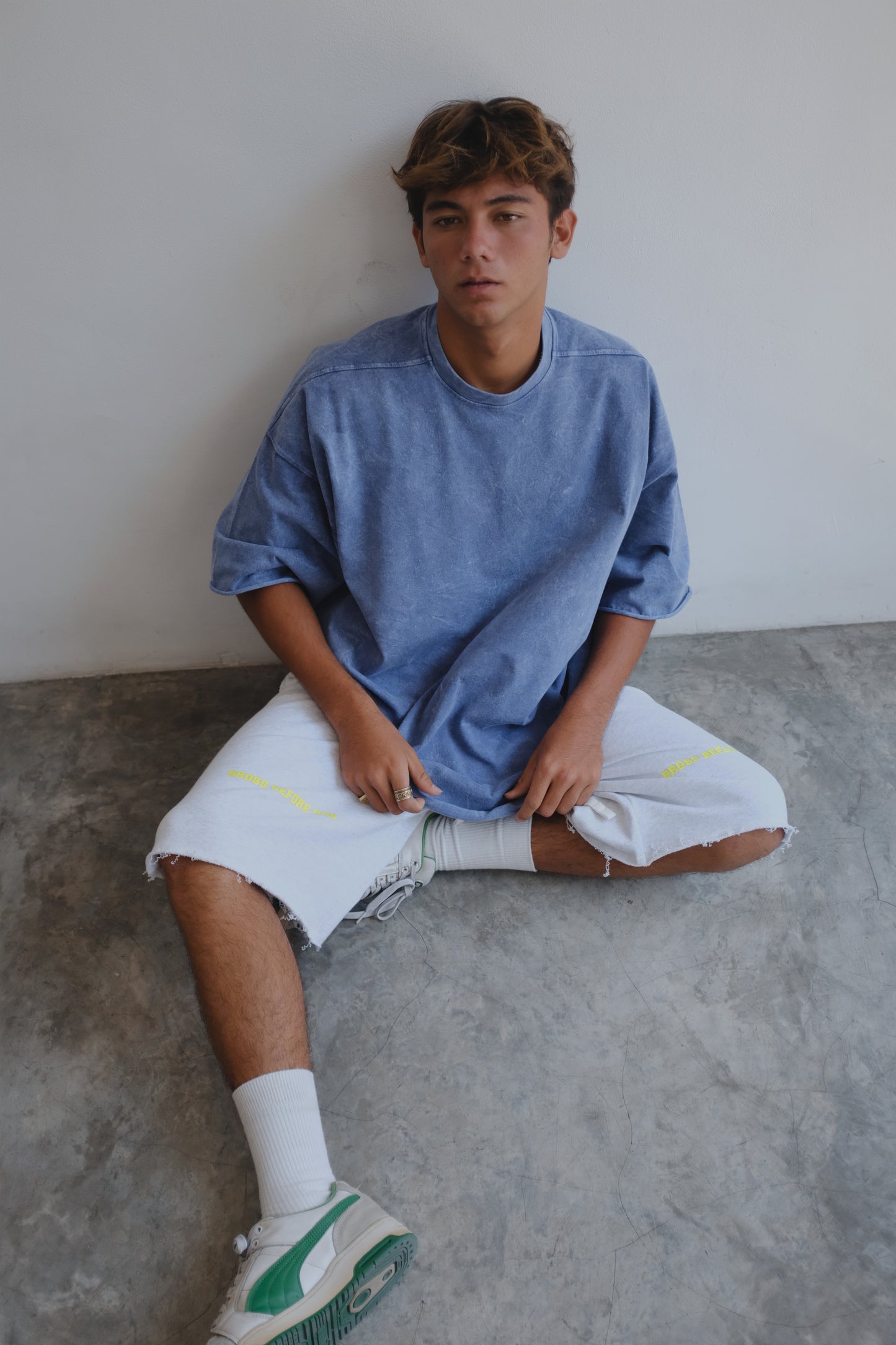 Blue stonewashed BROSS BEFORE HOS BOUTIQUE T-shirt displayed flat, showcasing its casual fit and textured fabric.