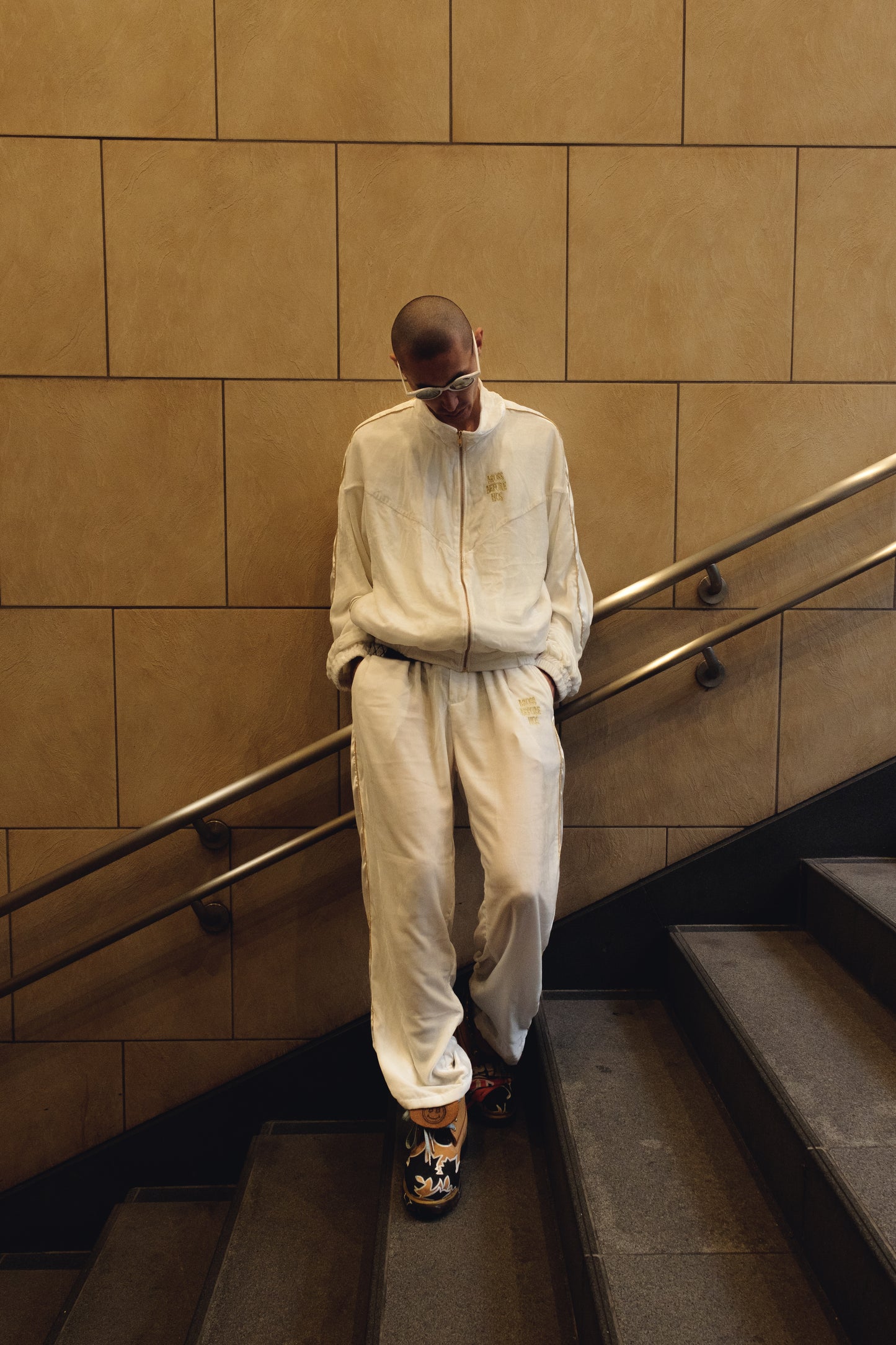 White silk velvet track pants from Bross Before H Os Boutique, featuring a relaxed fit and soft, luxurious fabric.