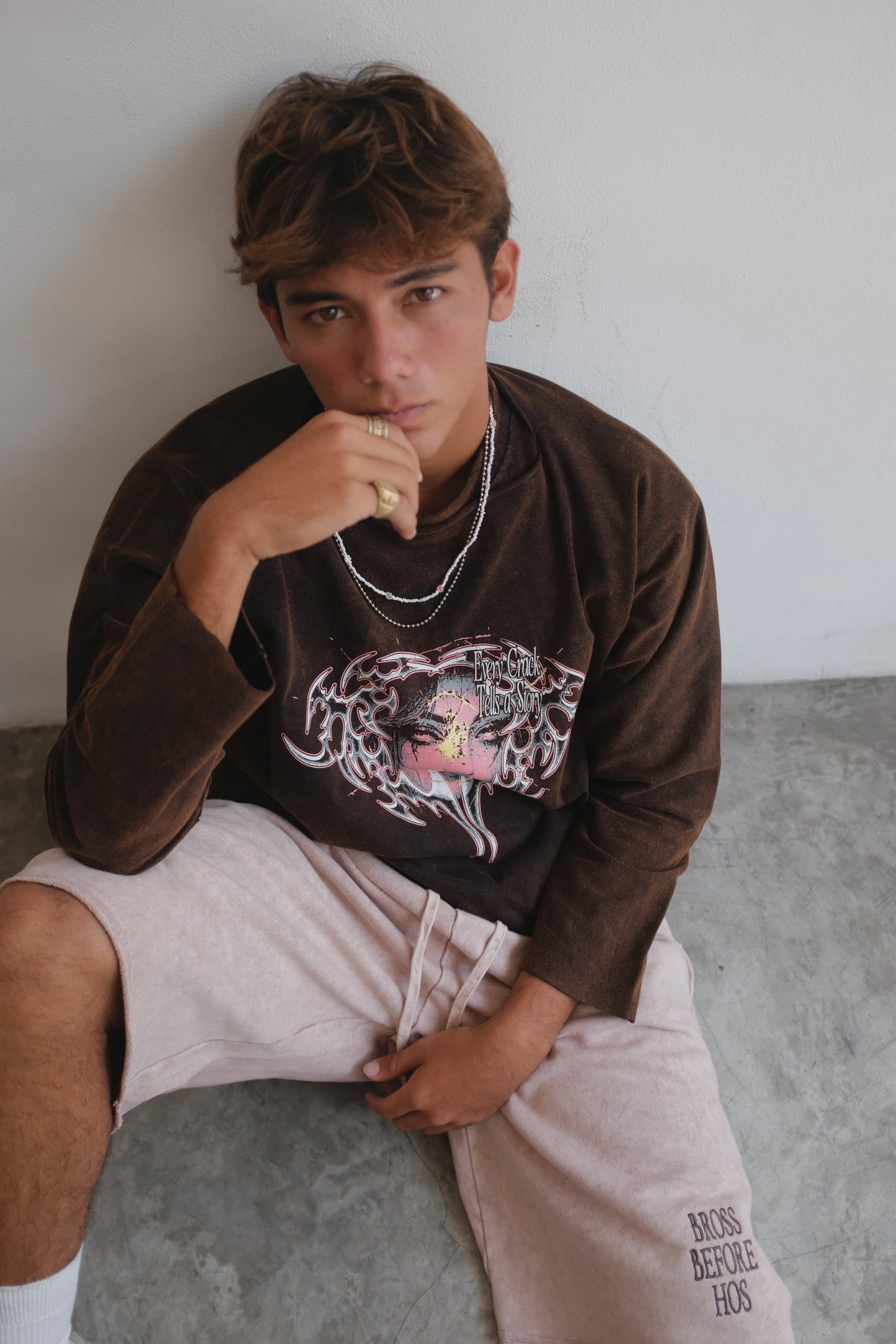 Brown long-sleeve T-shirt with a face print from Bross Before HOS Boutique, featuring a casual, graphic design.