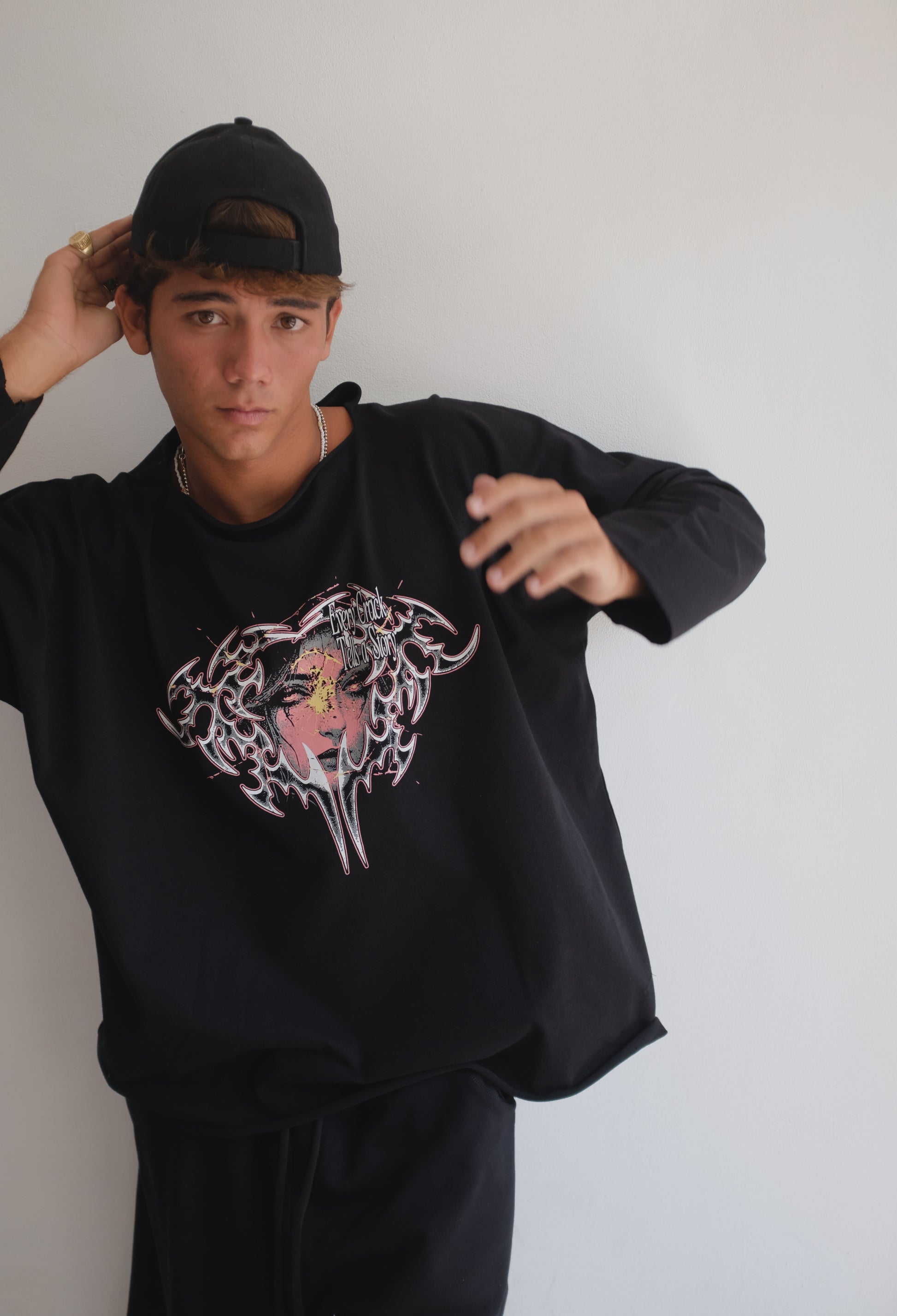 Black long-sleeve T-shirt with a face print from Bross Before Hos Boutique, featuring bold graphic design and comfortable fit.