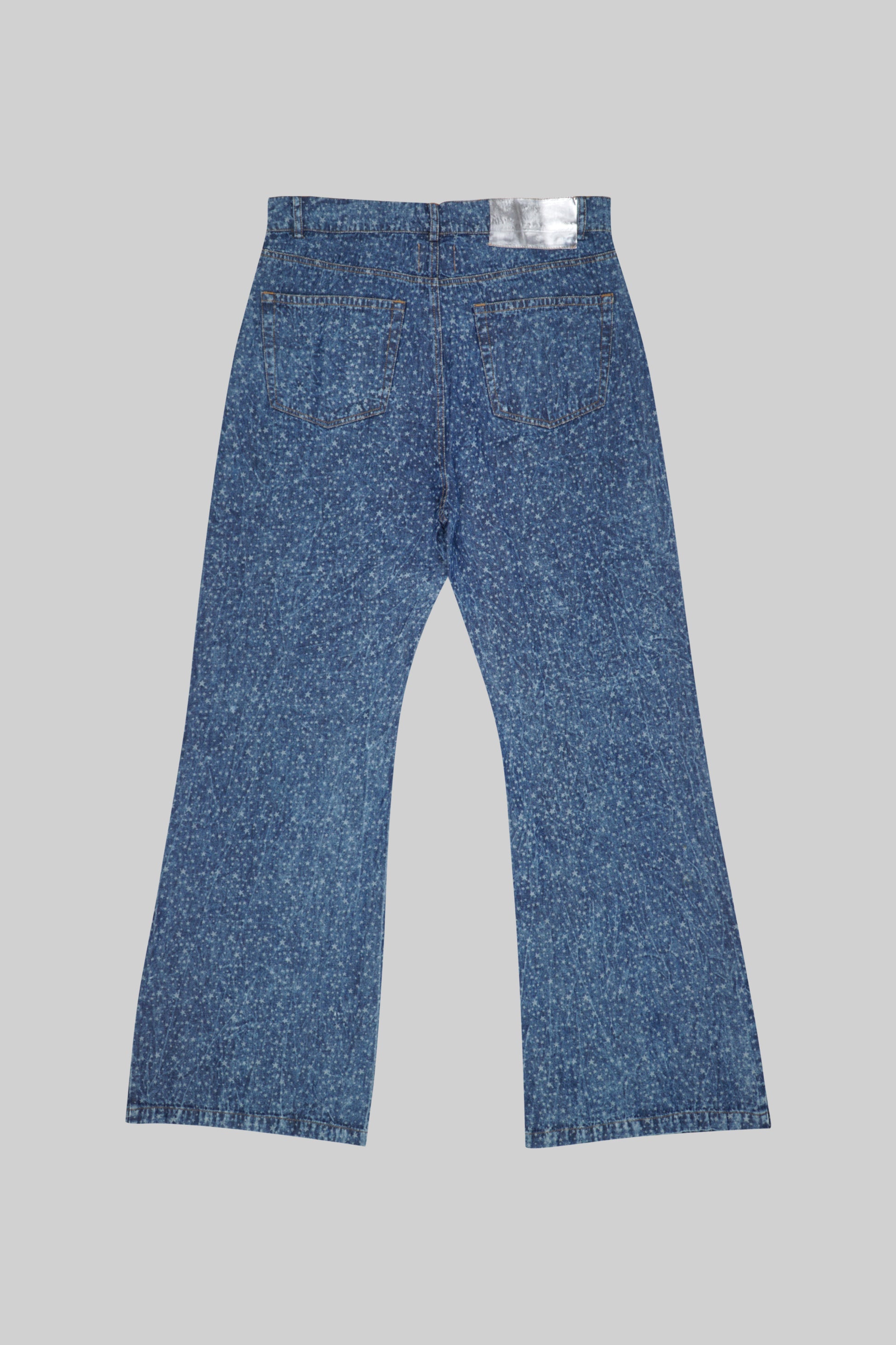 Blue jeans pants with star patterns by Bross Before Hos Boutique, showing a close-up of the fabric and star details.