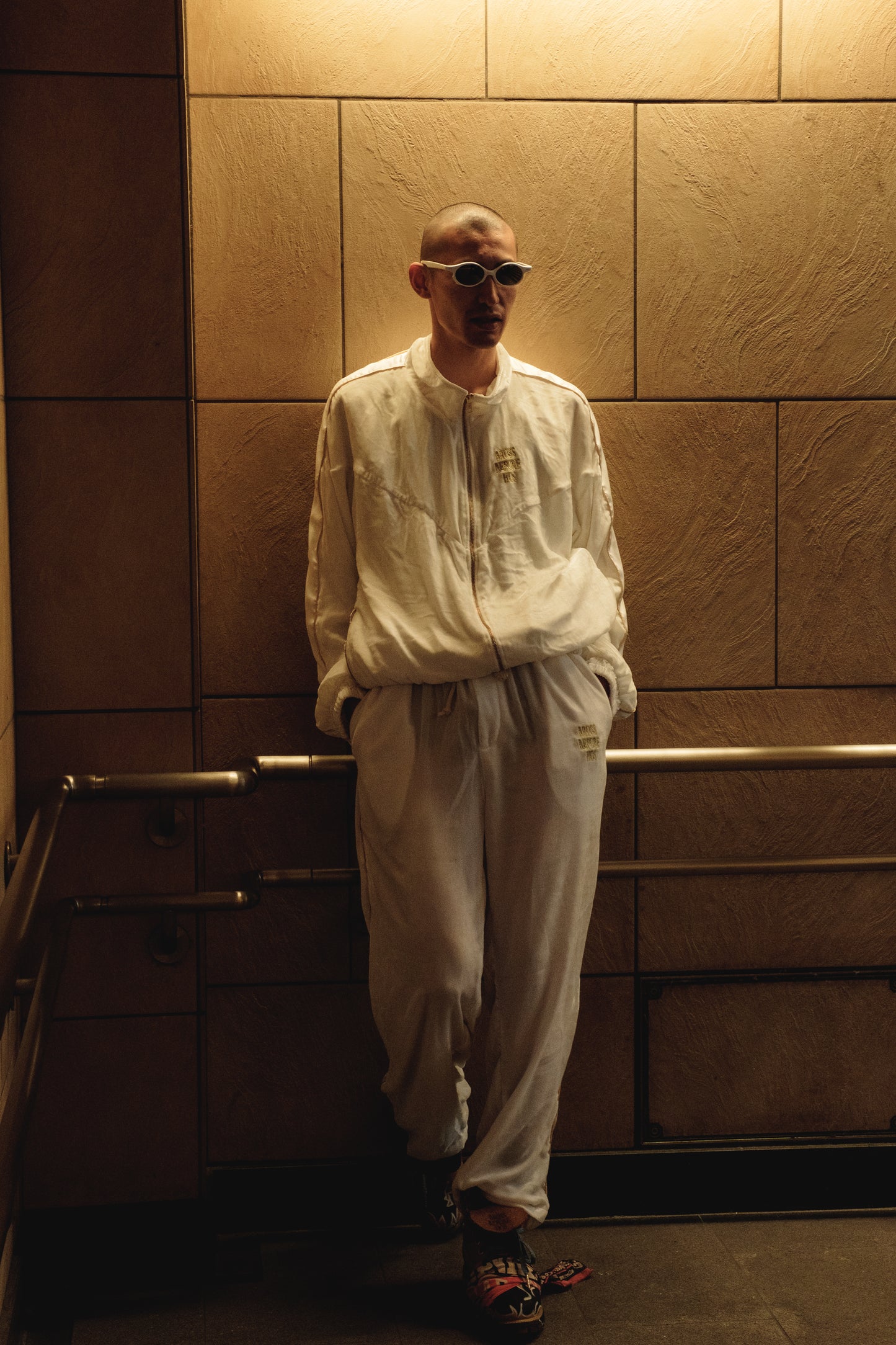 White silk velvet track pants from Bross Before Hos Boutique, shown with a relaxed fit and elastic waistband.