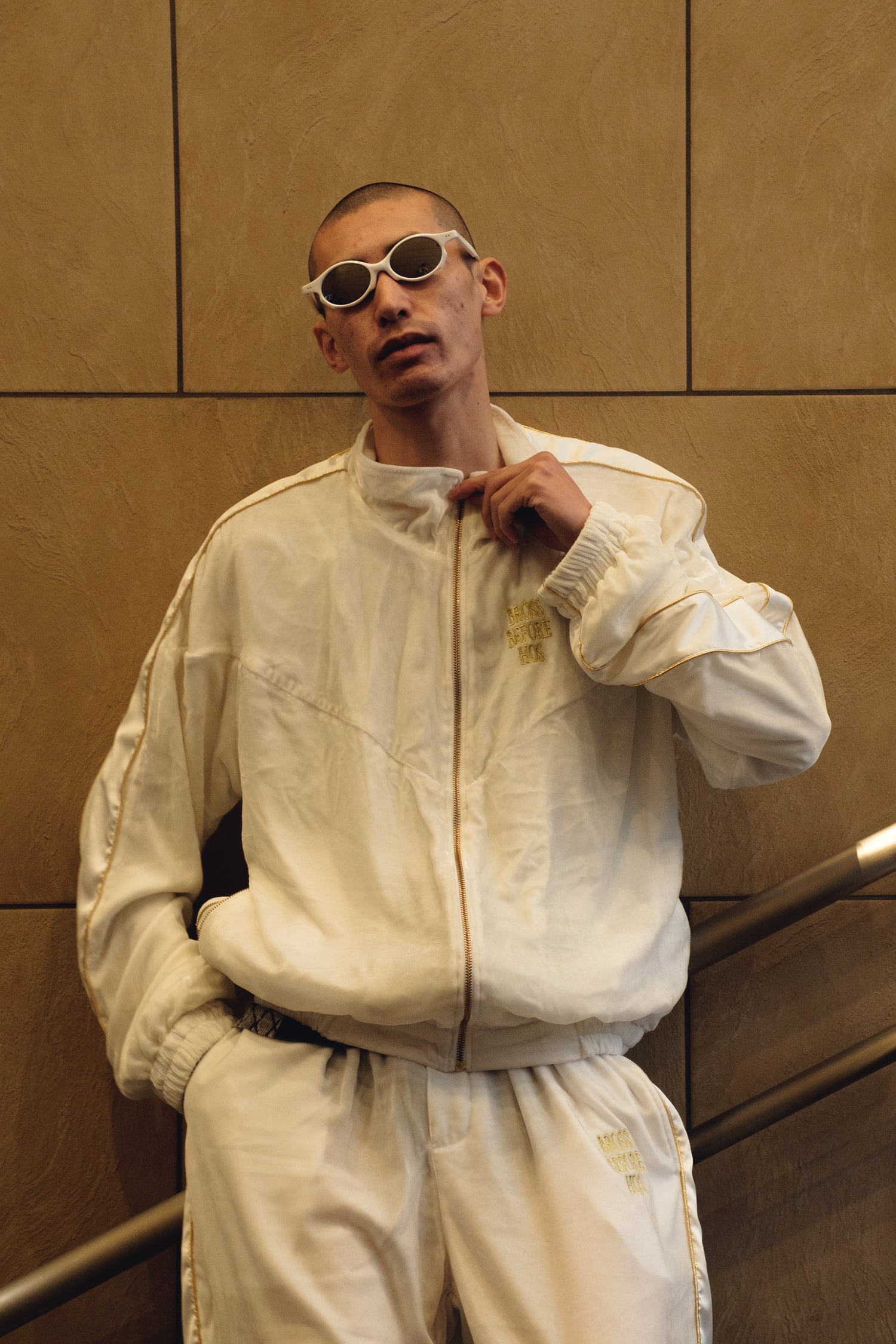 White silk velvet track jacket from Bross Before Hos Boutique, featuring a stylish, smooth fabric with a modern fit.