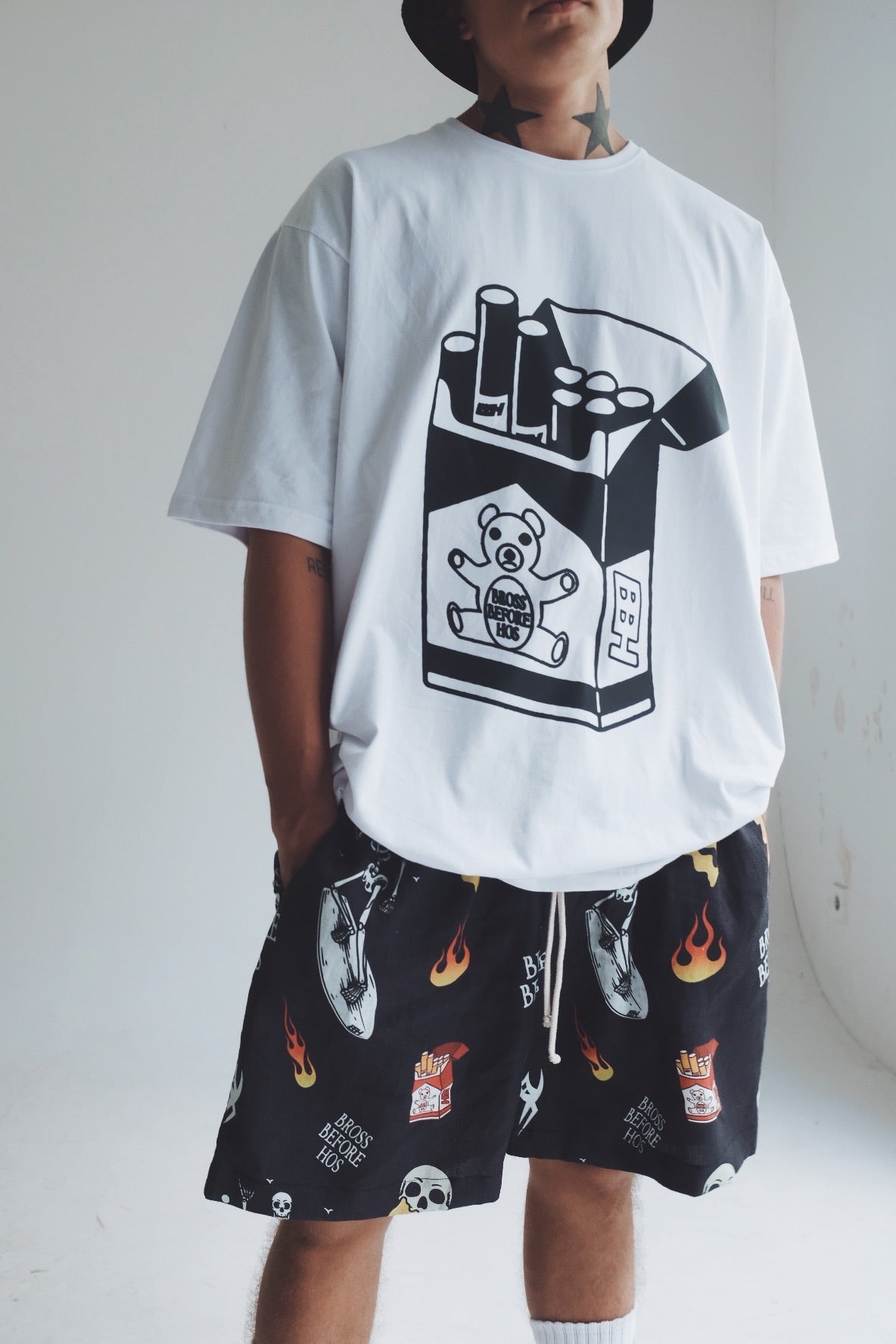 White and black cotton T-shirt with cigarette print from Bross Before Hos Boutique, casual and stylish men's apparel.