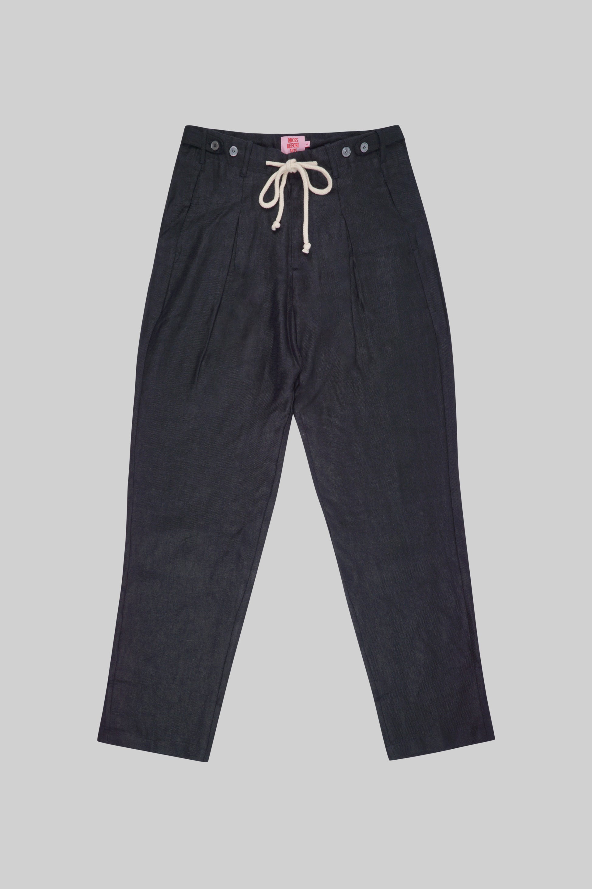 Light beige linen pants from Bross Before Hos Boutique, featuring a relaxed fit and side pockets.