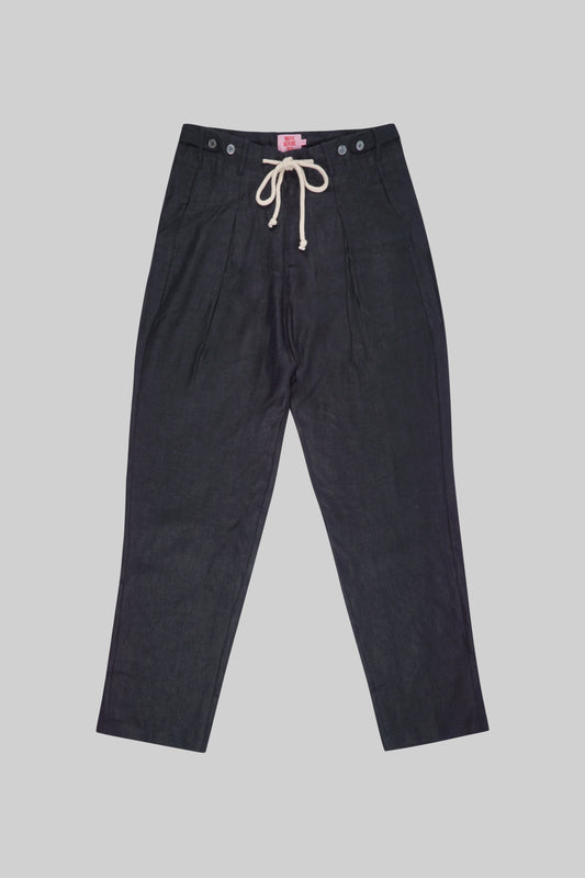 Light beige linen pants from Bross Before Hos Boutique, featuring a relaxed fit and side pockets.