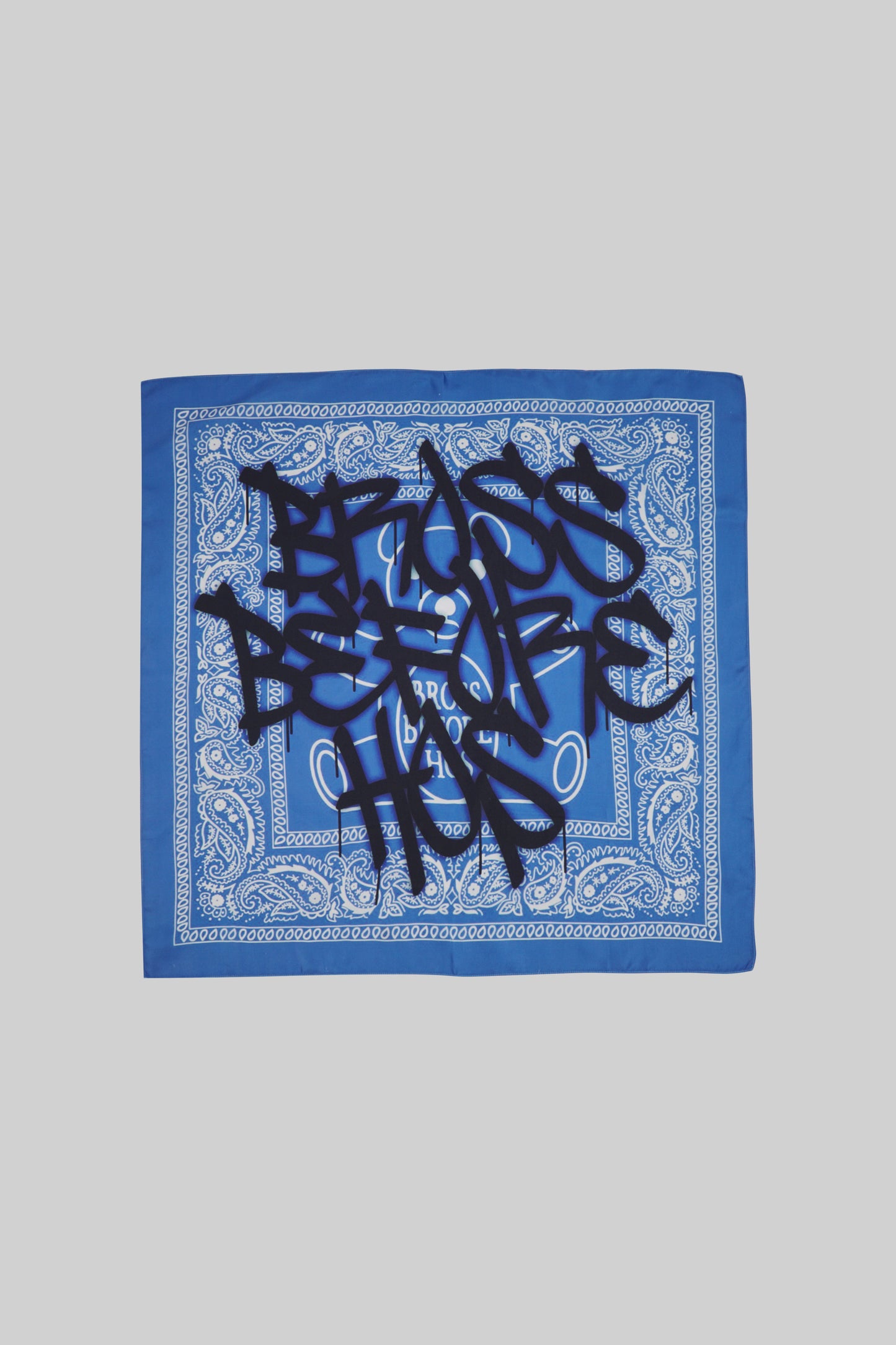 Elegant silk scarf by Bross Before HOS Boutique, featuring vibrant colors and intricate patterns, displayed flat.