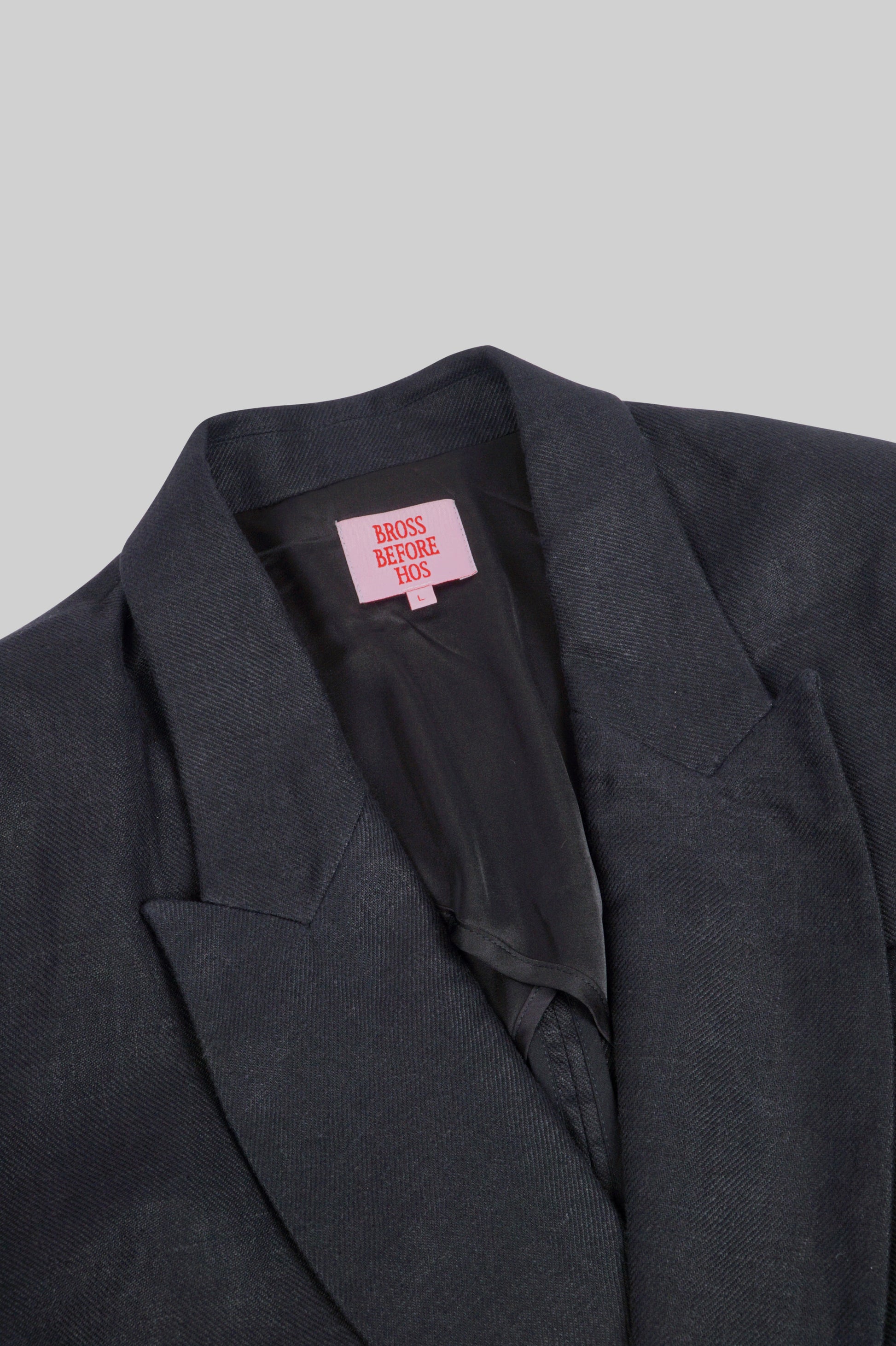 Black linen jacket from Bross Before H Os Boutique, featuring a relaxed fit and lightweight fabric for casual style.