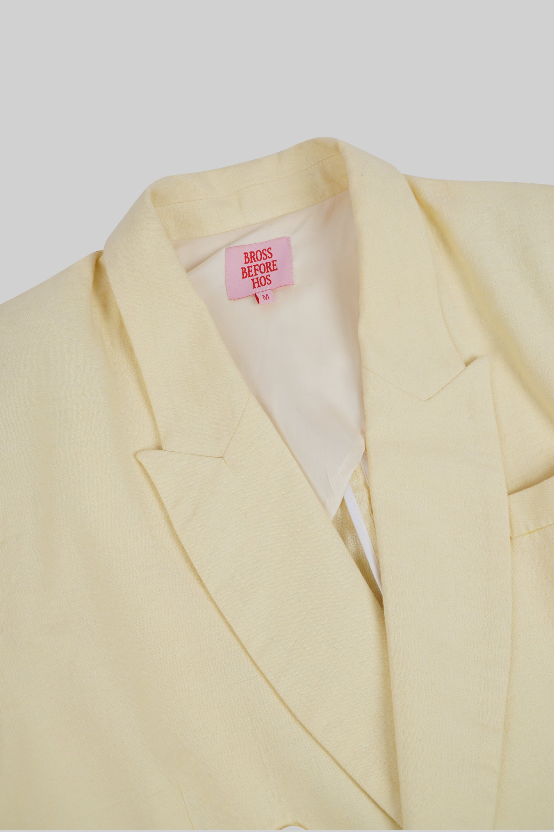 Light beige linen jacket from Sun Pressed by Bross Before Hos Boutique, featuring a relaxed fit and button closure.