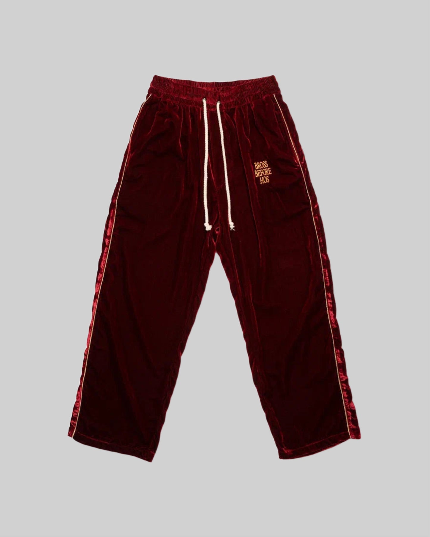 Red silk velvet track pants from Bross Before Hos Boutique, featuring a comfortable, stylish fit and luxurious fabric.
