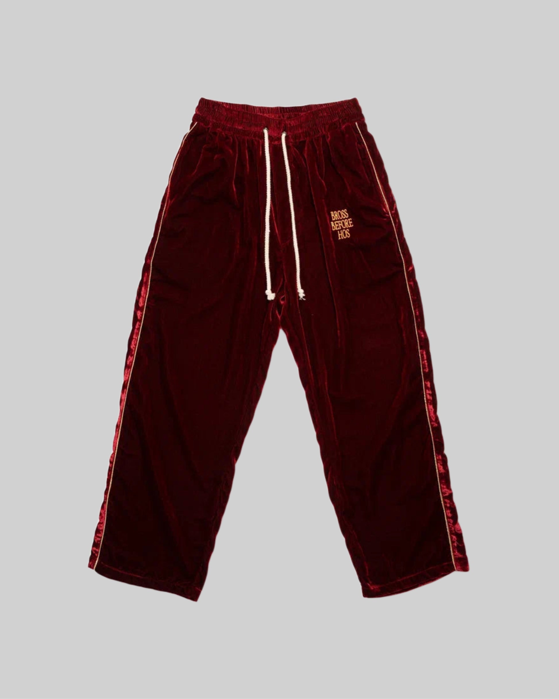 Red silk velvet track pants from Bross Before Hos Boutique, featuring a comfortable, stylish fit and luxurious fabric.