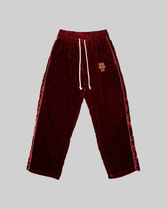 Red silk velvet track pants from Bross Before Hos Boutique, featuring a comfortable, stylish fit and luxurious fabric.